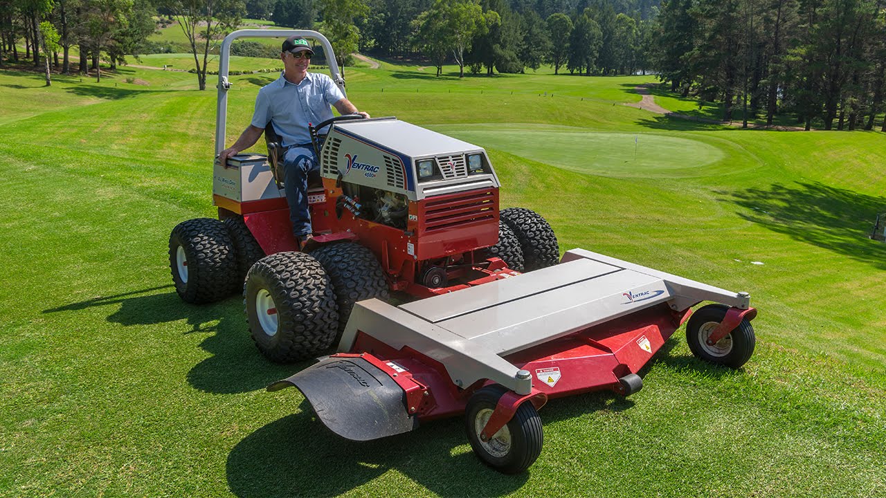 An Axiom crew member mowing turf grass at a Summit County property